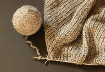 Close up knitting yarn and knitting fabric in progress