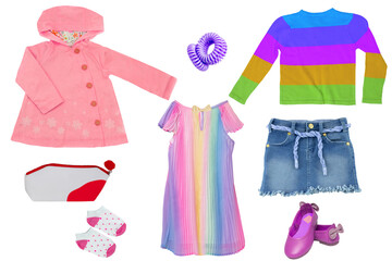 Collage set of little girls summer clothes isolated on a white background. The collection consists of a blue denim skirt, a rain coat, a shirt, shoes, a rainbow-coloured dress and accessories. Child f