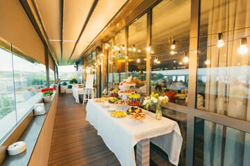 Festive buffet table with delicious desserts of different colors at the wedding ceremony
