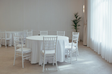 white round tables covered with a tablecloth to celebrate in the restaurant part of the decor and interior