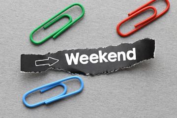 WEEKEND text on a black piece of paper. Time for the weekend after the work week. Concept for business.