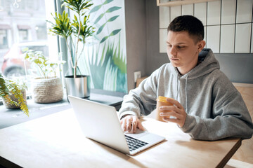 A man works in a cafe on a laptop. Writes an email to clients. An employee counts finances in an online table.