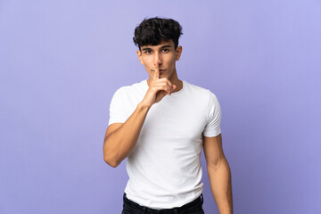 Young Argentinian man isolated on background showing a sign of silence gesture putting finger in...