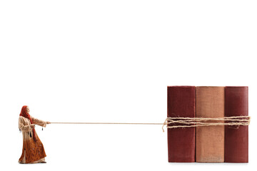 Full length profile shot of a woman in ethnic clothes and hijab pulling hardcover books tied with a rope