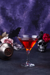 Halloween martini cocktail on purple background