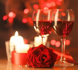 Red rose with chocolates and Candles on the desk