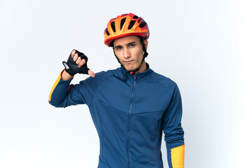 Young cyclist man isolated on background showing thumb down with negative expression