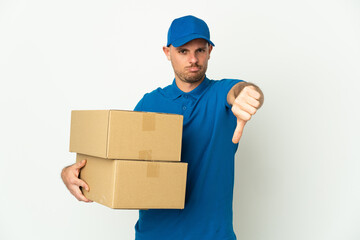 Delivery caucasian man isolated on white background showing thumb down with negative expression