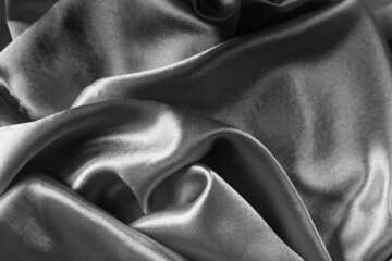 Elegant bright satin with waves. Fabric backdrop, view from above. Luxury cloth texture. Prefect as an abstract background with copy space, close-up.