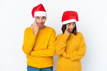Young mixed race couple celebrating Christmas isolated on white background looking to the front