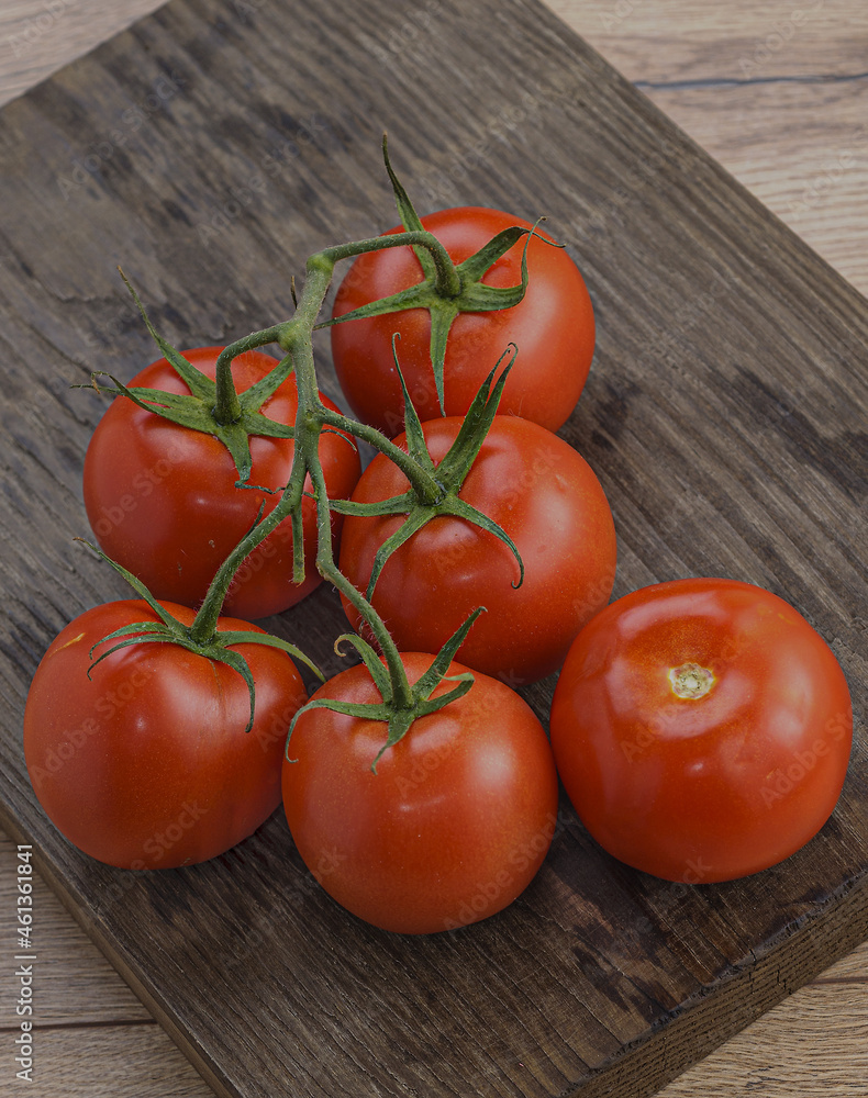 Poster Red appetizing cherry tomatoes on a wooden table