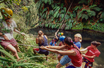 Team building using ropes to cross river