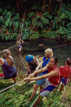 Team building using ropes to cross river