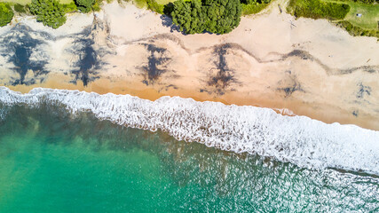 Aerial view on a sunny beach. Coromandel, New Zealand.