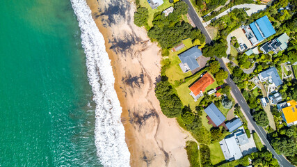 Fototapeta premium Residential houses on the sunny beach. North Island, New Zealand.