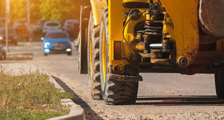 Tractor on construction site, close-up to the big wheels, banner