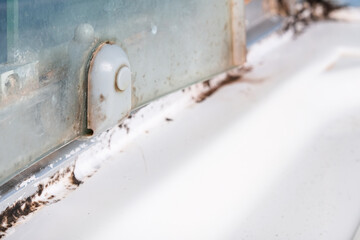 Mold fungus and rust growing in tile joints in damp poorly ventilated bathroom with high humidity, wtness, moisture and dampness problem in bath areas and shower