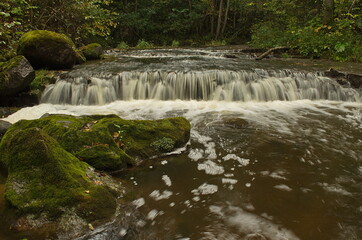 The rocky Valgale waterfall, photographed with a long exposure in autumn day, Latvia.