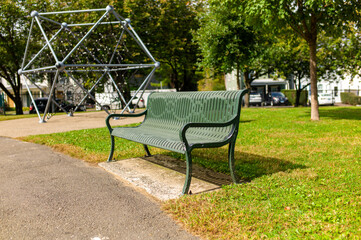 green metal chair on the green grass