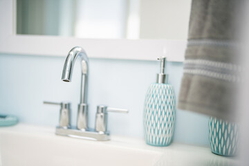 Obraz na płótnie Canvas Stainless steel bathroom sink faucet with soap dispenser