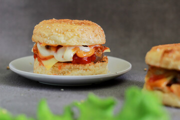 beef burger with tomato sauce and mayonnaise on a dark background
