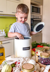 Child boy puts food waste in a compost bin. Waste sorting.