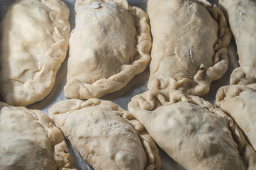 pasta with the name of raw fogazza in a metal baking dish, texture