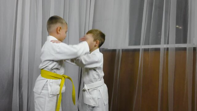 Two little athletes perform double throw grapple exercises