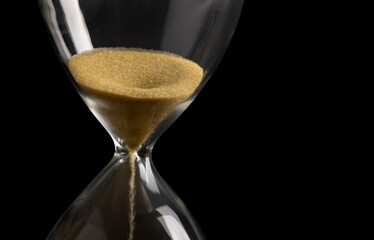 Sand clock , Hourglass as time passing on isolated black background , Life time concept