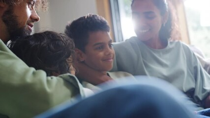 Slow motion of family on sofa smiling - Powered by Adobe