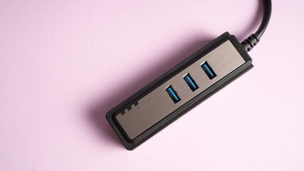 Multiple USB hub isolated on purple. Three ports USB charger
