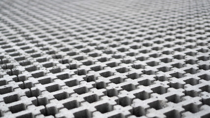 Gray eco pavement texture. Eco-paving stones. Eco paving without grass. Concrete eco stones with holes. Concrete tiles