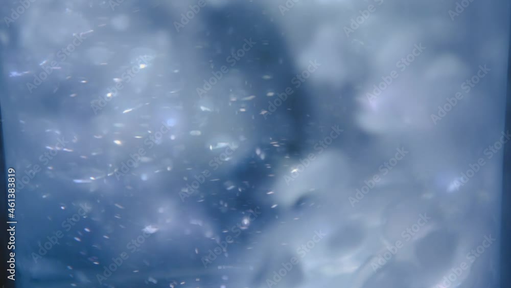 Poster close up motion stacked ice cubes collapsing with bubbles underwater