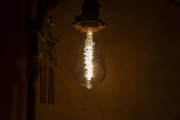 Vintage hanging Edison light bulb in a dark room