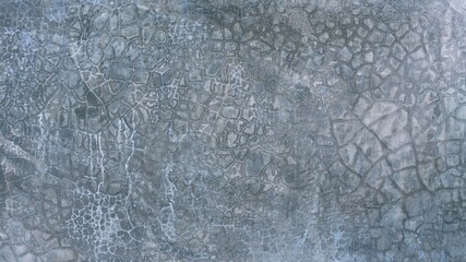 The old cement wall was weathered, the surface was scratched, the surface was scratched and damaged. For a mysterious retro-conservative background.