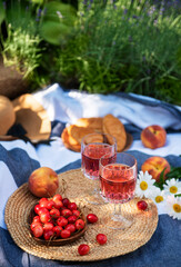 Fototapeta na wymiar Set for picnic on blanket in lavender field