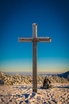 Tall catholic cross on a mountain peak, Western Tatras, border of Poland and Slovakia. The view from Grześ (L&uacute;čna) Summit. Selective focus on the wooden structure, blurred background.