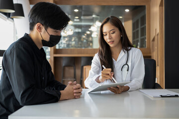 Young man patient having consultation with doctor in hospital.