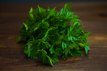 Green fresh parsley on wooden table	
