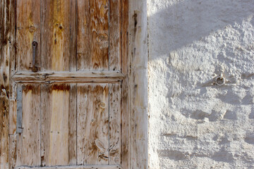 old wooden door adobe wall in the countryside