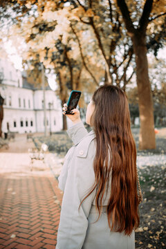 person takes pictures on the phone autumn landscape