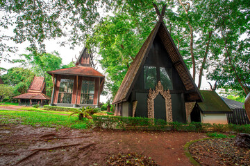 Fototapeta na wymiar Background of tourist attractions in Chiang Rai of Thailand, Baan Dam or Baan Dam Museum is an art museum. will be a group of wooden houses Lanna Art Strange shaped cement house, Thai style house The 