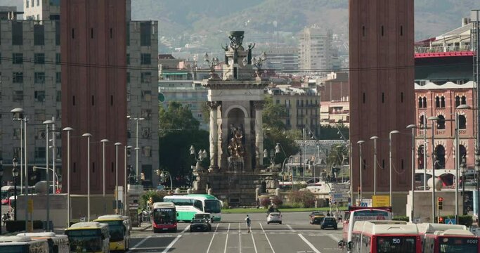 Placa d'Espanya Between Torres Venecianes With Traffic At Avinguda de la Reina Maria Cristina In Barcelona, Spain. - wide shot