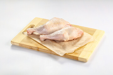Raw chicken leg over background