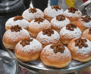 Fresh donuts with chocolate at the bakery display for Hanukkah celebration. Selective focus.