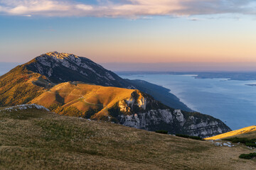 sunrise at lake garda from monte altissimo with view of south side of the lake in the morning, italy