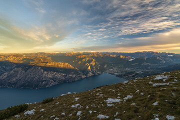 North side of lake garda at sunrise with view of the mountains and city turbel and riva del garda. Taken from mountain monte altissimo