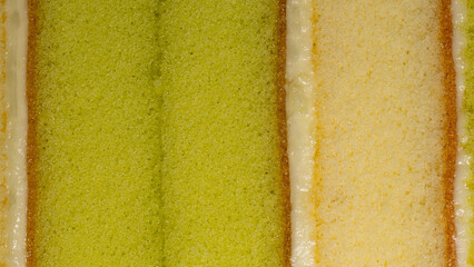 Sponge cake texture. Layer cake, center green pandan leaves and cream, topped with vanilla flavor.