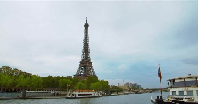Majestic Eiffel Tower with fast moving boats in hyperlapse shot