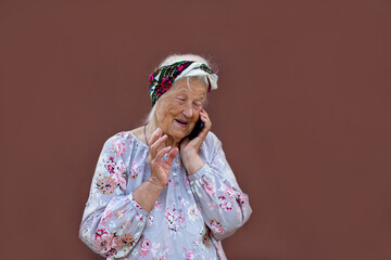Grandmother portrait set in the studio. Concepts about seniority. Elderly woman emotionally talking on the phone